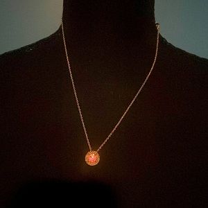 Gold tone necklace set with matching earrings with pink jewels